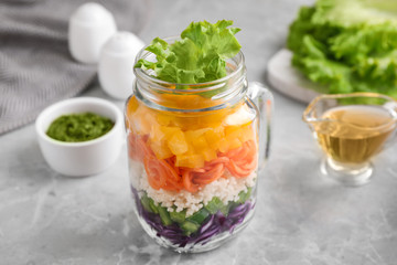 Fototapeta na wymiar Healthy salad in glass jar on marble table