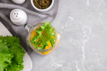 Healthy salad in glass jar on marble table, flat lay. Space for text