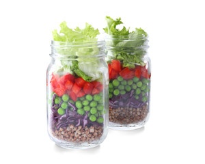 Fototapeta na wymiar Healthy salad in glass jars isolated on white