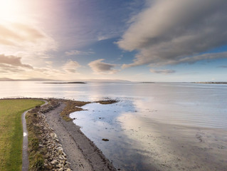 Aerial view on Hare island in Galway bay. Cloudy sky, Atlantic ocean, Walking path by the ocean. Ballyloughane area.