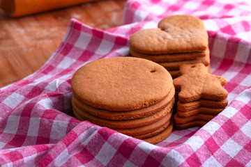 Preparation for the holiday. Baked gingerbread cookies for the new year. Gingerbread blanks before drawing. Gingerbread cookies with holes for hanging on a Christmas tree. Holiday preparation.