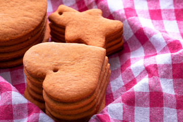 Preparation for the holiday. Baked gingerbread cookies for the new year. Gingerbread blanks before drawing. Gingerbread cookies with holes for hanging on a Christmas tree. Holiday preparation.