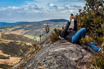 Young woman exploring the nature of a beautiful paramo at the department of Cundinamarca in Colombia