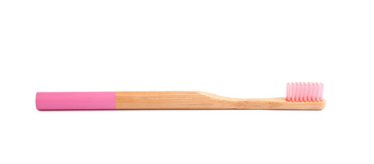 Bamboo toothbrush with pink bristle isolated on white