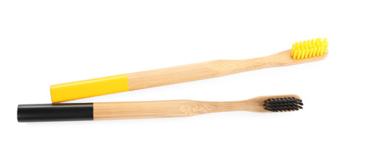 Natural toothbrushes made with bamboo isolated on white, top view