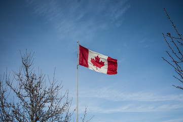 The Canadian flag in a blue sky