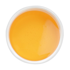 Bowl of organic honey isolated on white, top view