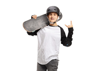 Kid posing with a skateboard and gesturing rock and roll sign © Ljupco Smokovski