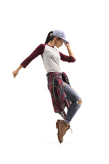 Young trendy casual female dancing on tiptoes