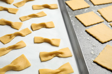 Homemade farfalle pasta on grey table, closeup