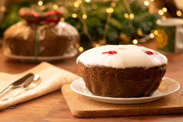 Traditional Christmas fruit cake, pudding with dried fruits, nuts and white glaze.