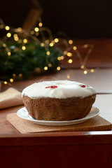Fototapeta na wymiar Traditional Christmas fruit cake, pudding with dried fruits, nuts and white glaze.