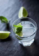 Gin and Tonic on black stone background. Close up. 