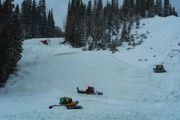 Snowcats on mountain side after winter storm