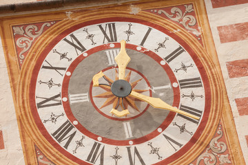 Naklejka premium A detail of the clock painted on the bell tower of the St. Cristina little church in Val Gardena, recently restored it shows all its original vivid colors