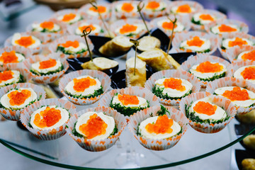 Canape with butter and red caviar. Furshet.