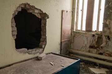 Hole punched through the wall of a prison cell for an escape.