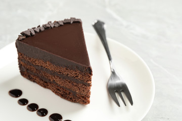 Piece of tasty chocolate cake served on plate