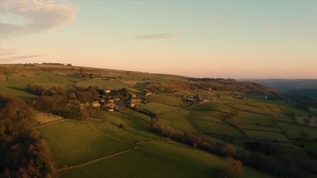 High Bradfield village aerial footage during a low orange sunset in December of 2019, Sheffield, South Yorkshire, Winter.