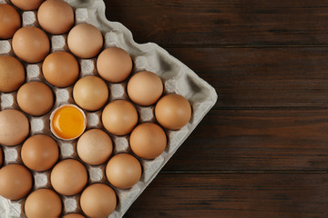 Raw chicken eggs on wooden table, top view