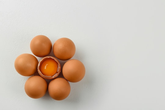 Raw chicken eggs on white table, flat lay. Space for text