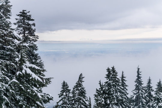 mountain top view over snow covered mountains and city from holyburn peak near Vancouver, Canada