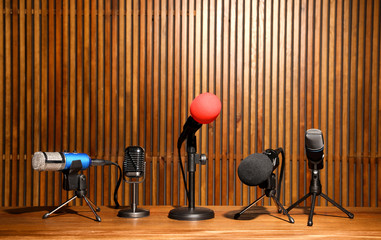 Set of different microphones on wooden table. Journalist's equipment