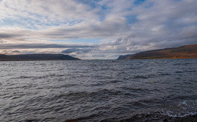 Naklejka na ściany i meble Blue sea water at a beach at Patreksfjordur at the west fjords of Iceland. September 2019