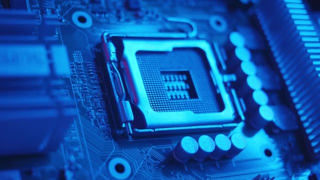Blue light macro electronic part of a computer disassemble the laptop debrief the computer parts circuit industry microprocessors metal technology engineering tech close up slow motion
