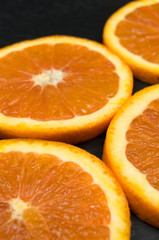 Delicious and Fresh Orange Slices on Black Background