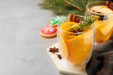 Aromatic white mulled wine on light grey table. Space for text