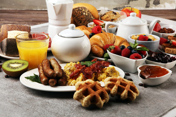 Breakfast served with coffee, orange juice, croissants, cereals and fruits. Balanced diet. Continental breakfast with granola and fruits