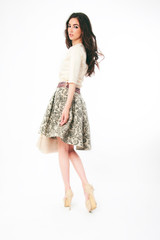 Fashion model posing in studio, vogue stylish spring summer skirt and blouse, make up and hairstyle 