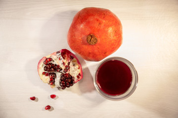 pomegranate and juice on wooden table