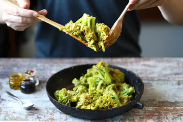 Broccoli cooked in a pan. Chef mixes broccoli. Healthly food.