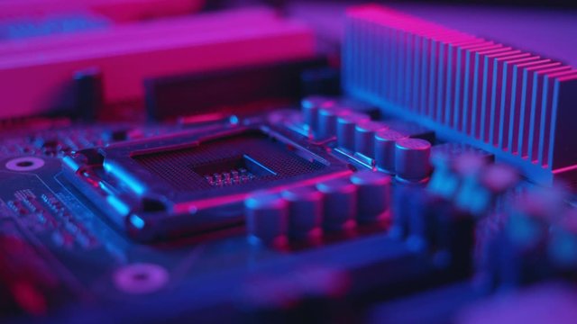 Blue light macro electronic part of a computer disassemble the laptop debrief the computer small parts circuit industry microprocessors metal technology engineering tech silicon background slow motion