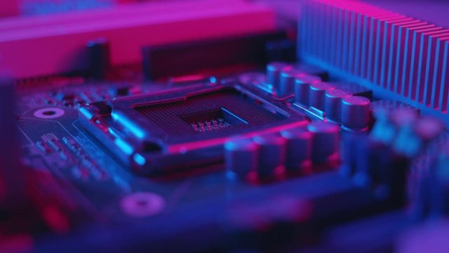 Shot with colorful light macro electronic part of a computer disassemble the laptop debrief the computer small parts circuit metal technology engineering tech silicon background slow motion