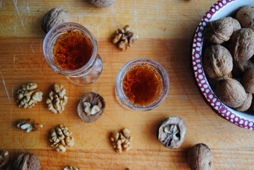 Two walnut brandy glasses on a wooden table - top view