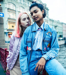 Two teenage girls infront of university building smiling, having fun, lifestyle real people concept