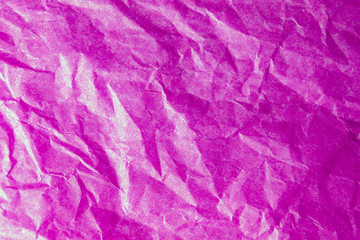 Bright pink crumpled paper texture background. The wrinkled crimson magenta design paper