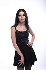 Fototapeta premium Beautiful young brunette woman in black dress on white background