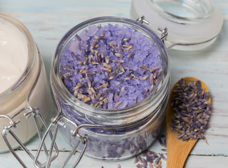 Homemade spa of lavender bath salts on a light wooden background.