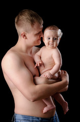 Male holding nice infant baby girl. New life concept. Daughter on father's arms