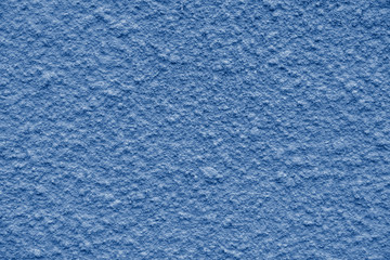 painted in trendy color of year 2020 Blue Classic chipped plaster on the weathered wall. close up view