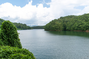 A landscape orientation and wide view of the river along the train tracks in North Carolina mountains.