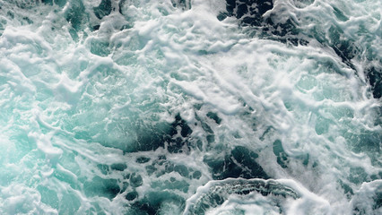 texture dark water of the deep ocean. sea ​​foam on the waves during a storm. natural composition in the ocean. aerial view, sea background. rough