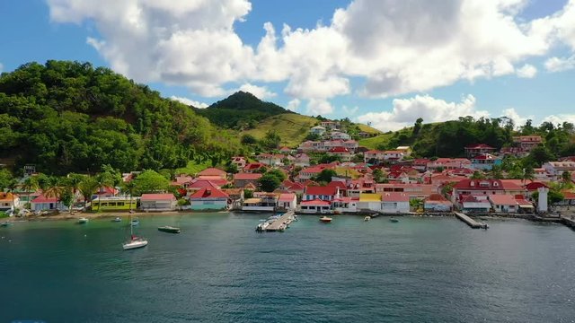 French West Indies - Colorful Guest Houses At The Lush Iles Des Saintes Island Located In Guadeloupe Alongside The Blue Sea - A Perfect Tourist Destination - Wide Shot