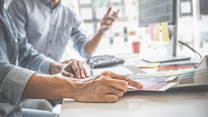 Graphic design and color swatches and pens on a desk. Architectural drawing with work tools and accessories.