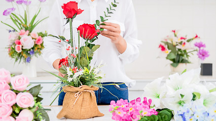 Woman hands making flower composition at florist workshop. Do it yourself concept.
