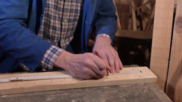 carpenter working in sheed on new piece